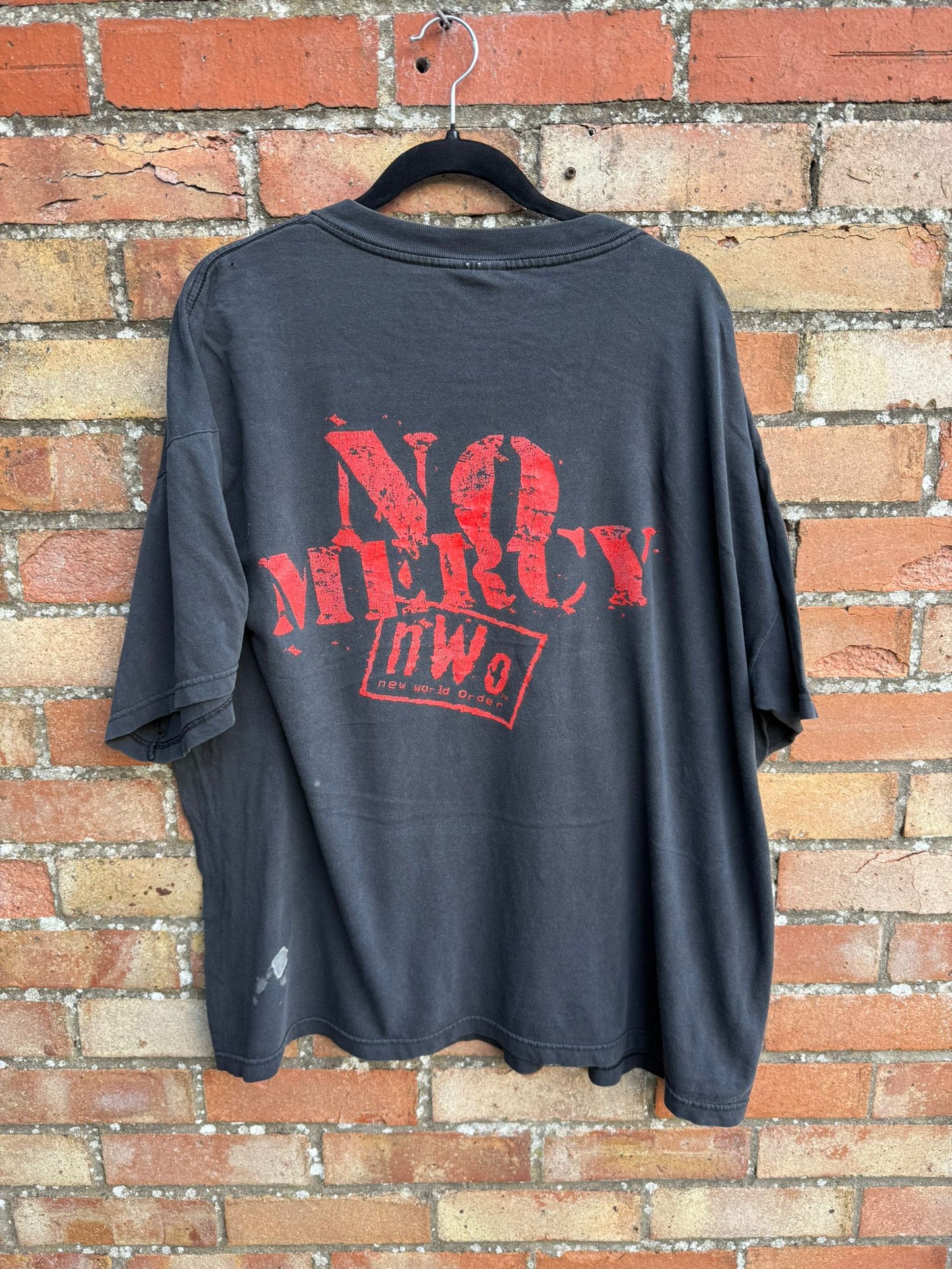 Black t-shirt with red text 'NO MERCY' and nWo logo