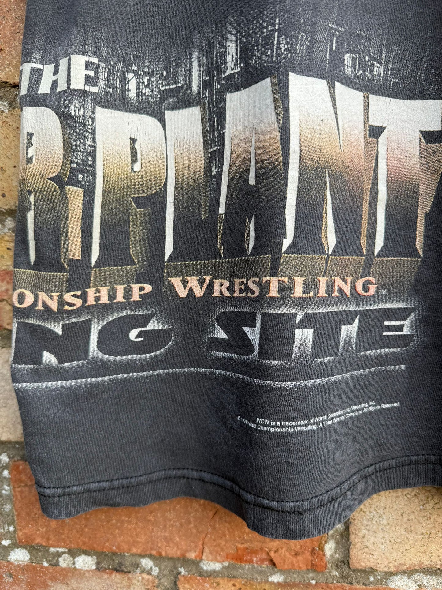 Black t-shirt with 'The Championship Wrestling Ring Site' and WCW branding