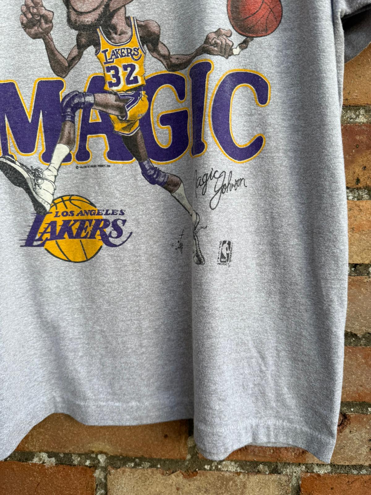 Gray t-shirt with a graphic of a basketball player in a Lakers jersey and 'Magic' text.