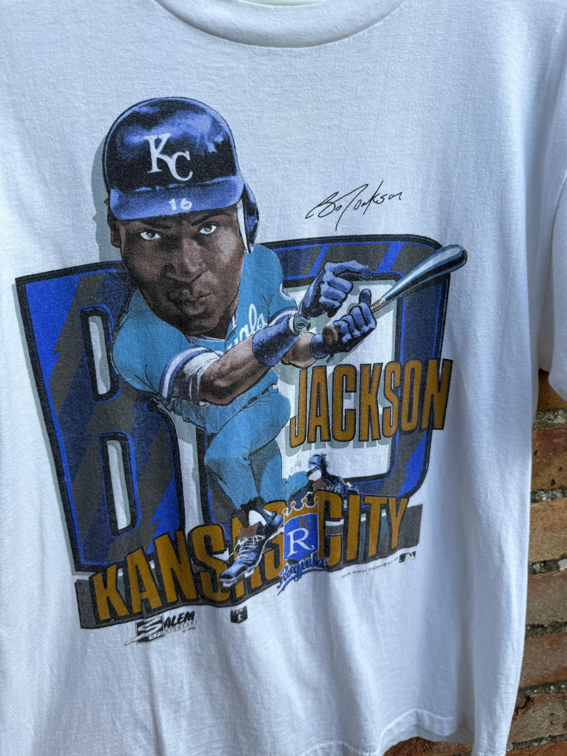 T-shirt with a close-up graphic of a baseball player Bo Jackson and print signature, and text on a white background