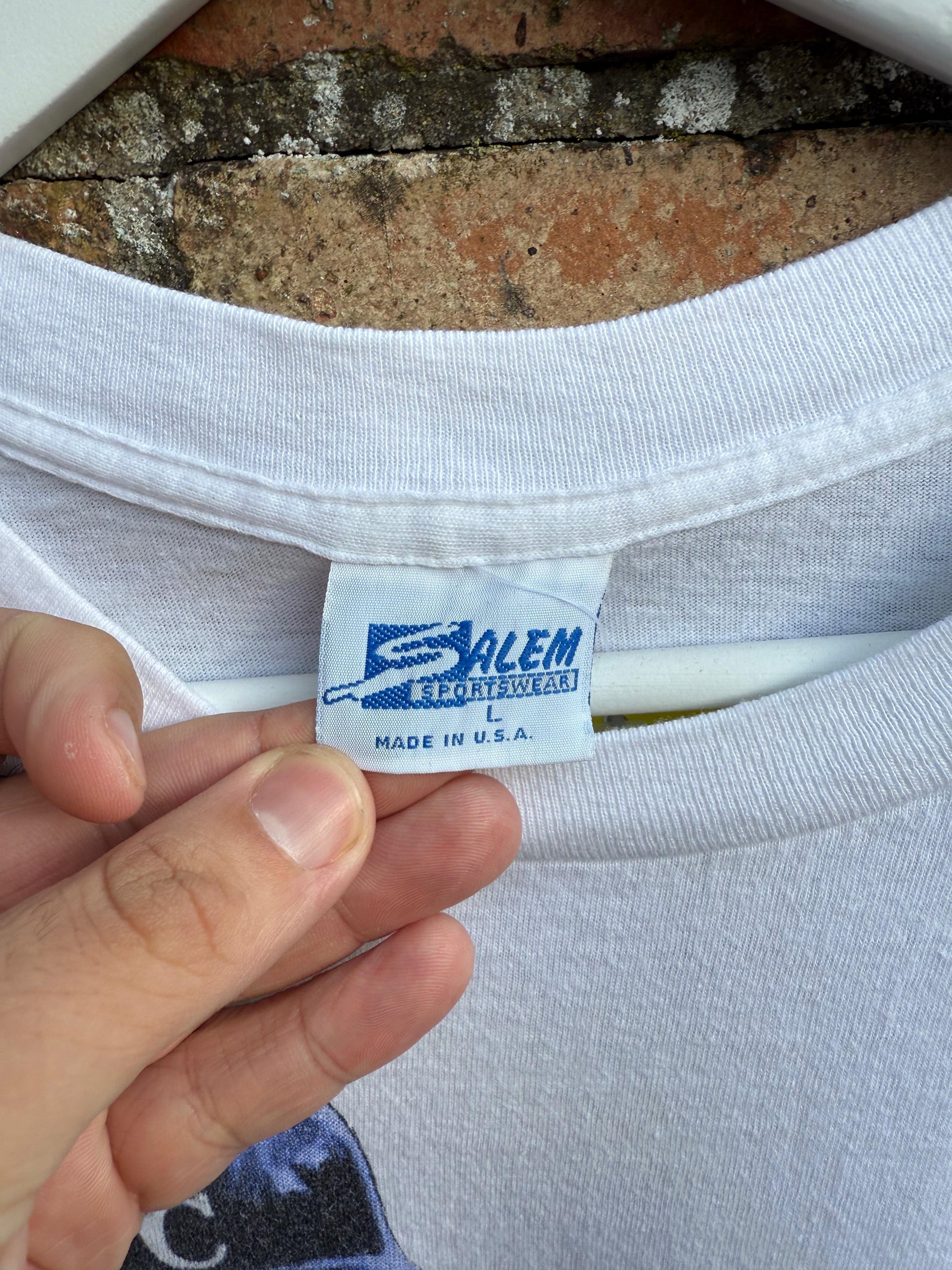 Salem Sportswear label on a white Made in USA shirt with a brick background