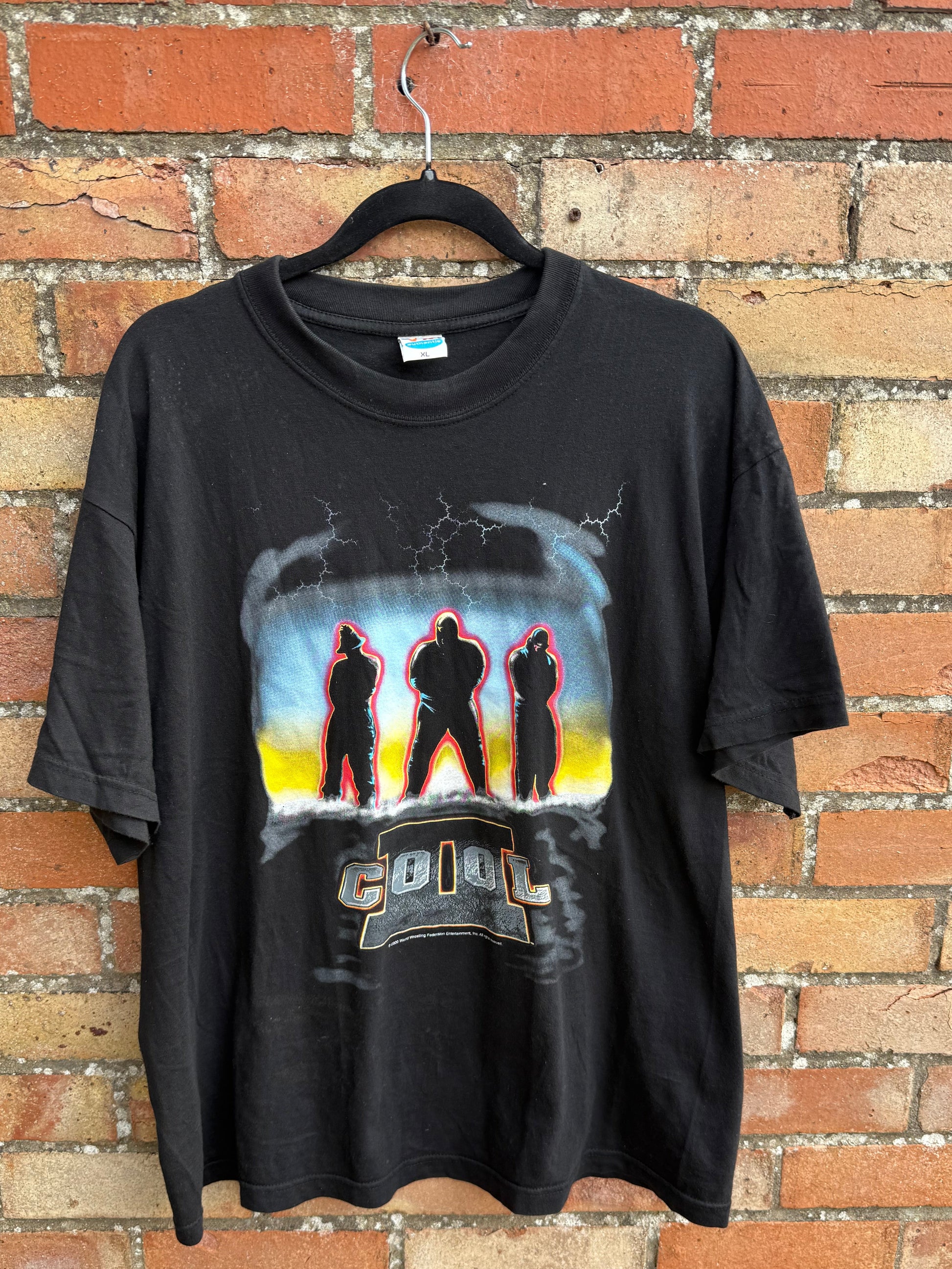 Black t-shirt with 2 Cool graphic design on a brick surface