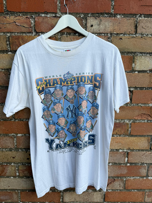 White t-shirt with New York Yankees World  Series Champions team, on a hanger against a brick wall