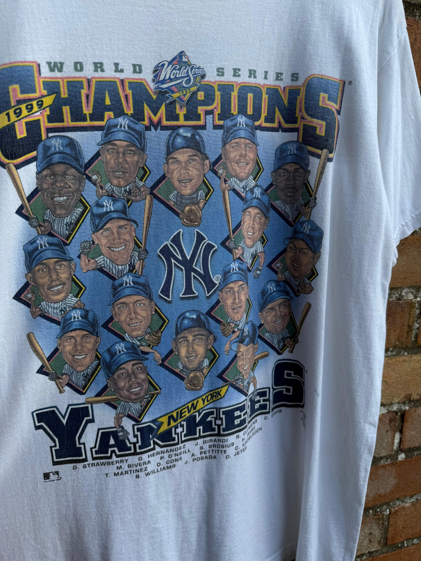 White t-shirt with New York Yankees World Series Champions 1999 design featuring caricatures of multiple players