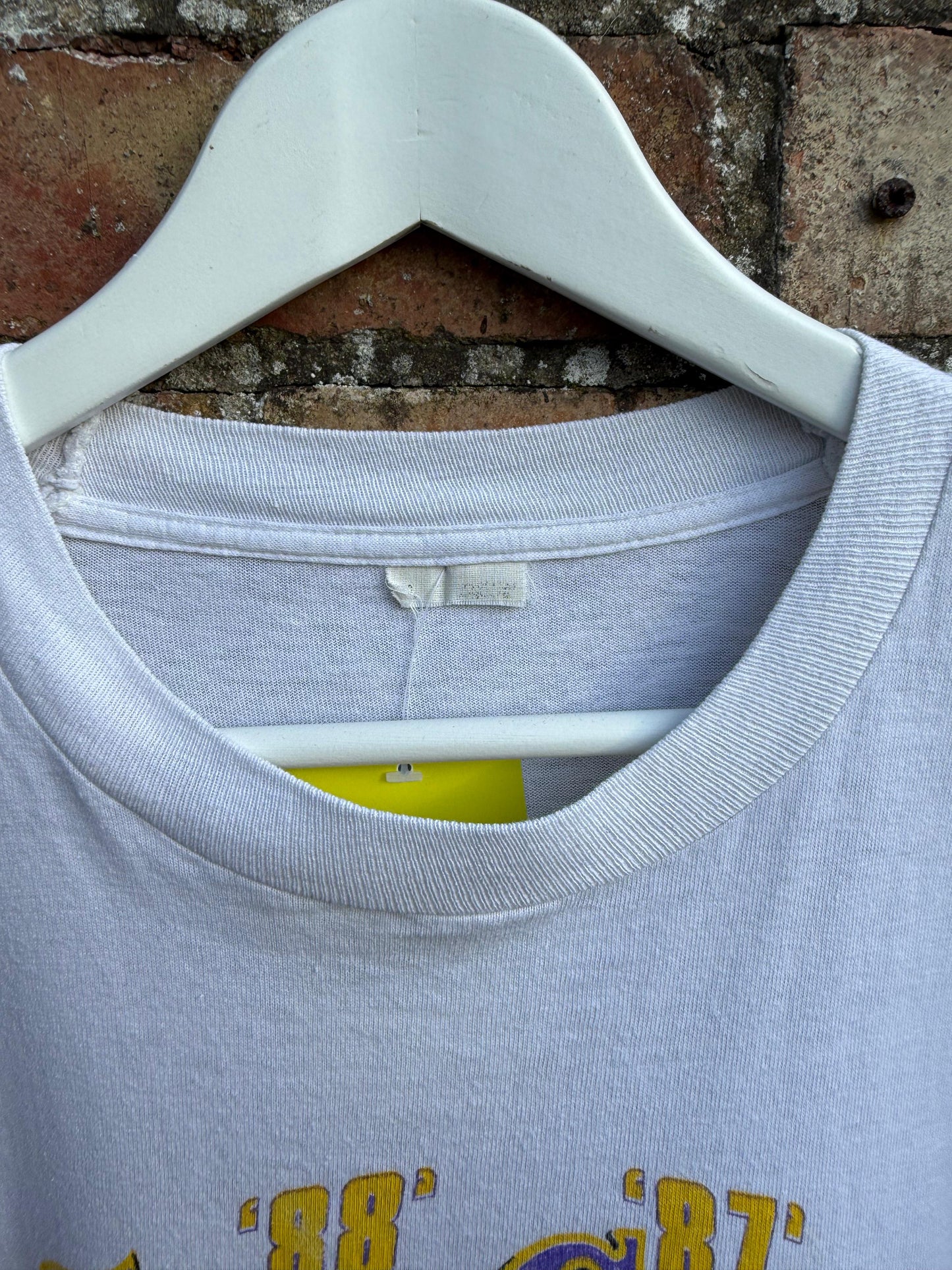 Close-up of a cut tag on a white t-shirt