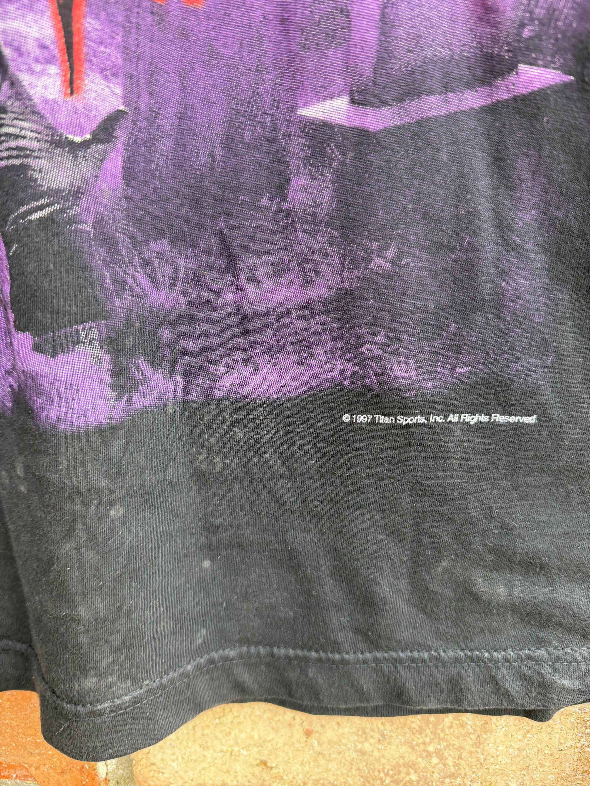 Close-up of a 1997 Titan Sports Inc copyright statement with purple graphic 