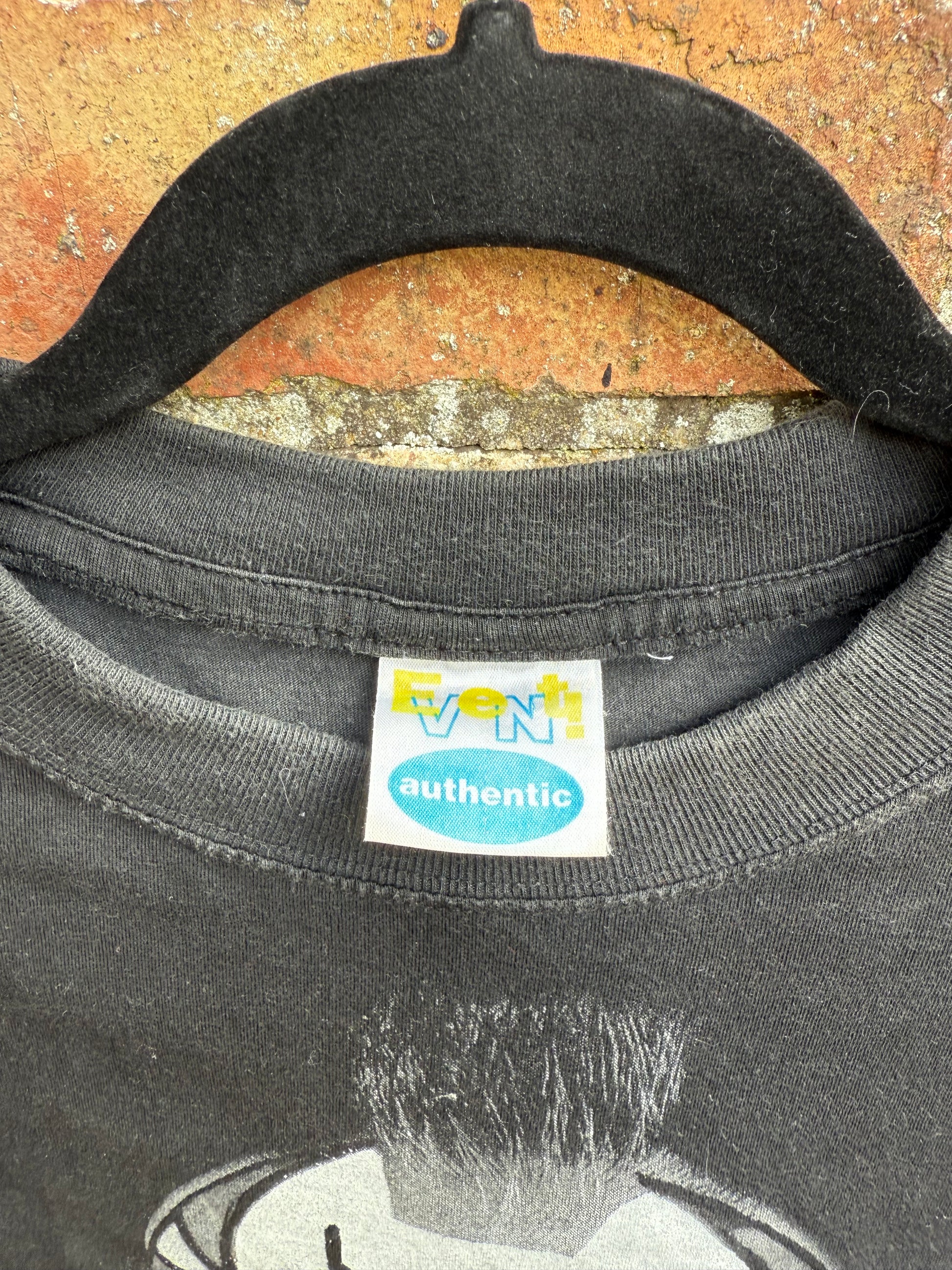 Close-up of an Event Authentic tag on a black t-shirt