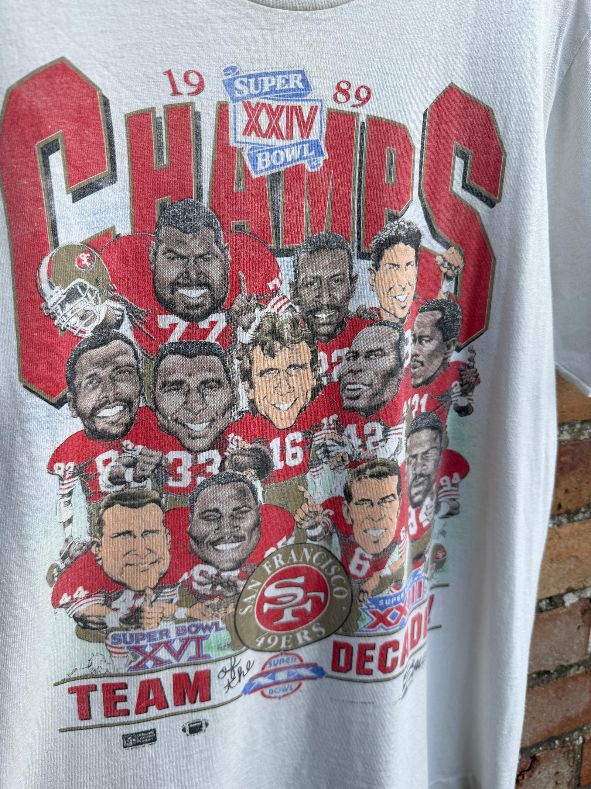 Vintage t-shirt celebrating Super Bowl XXIV champions San Francisco 49ers with player graphics and text.