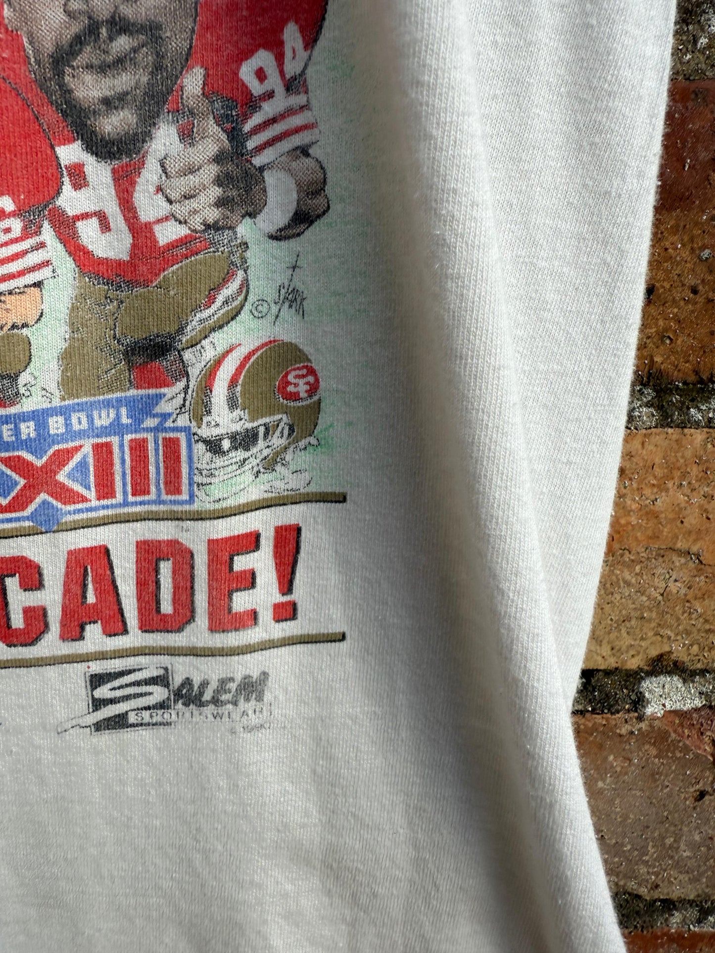 Vintage t-shirt with sports-themed Super Bowl graphic and Salem Sportswear text on a textured surface