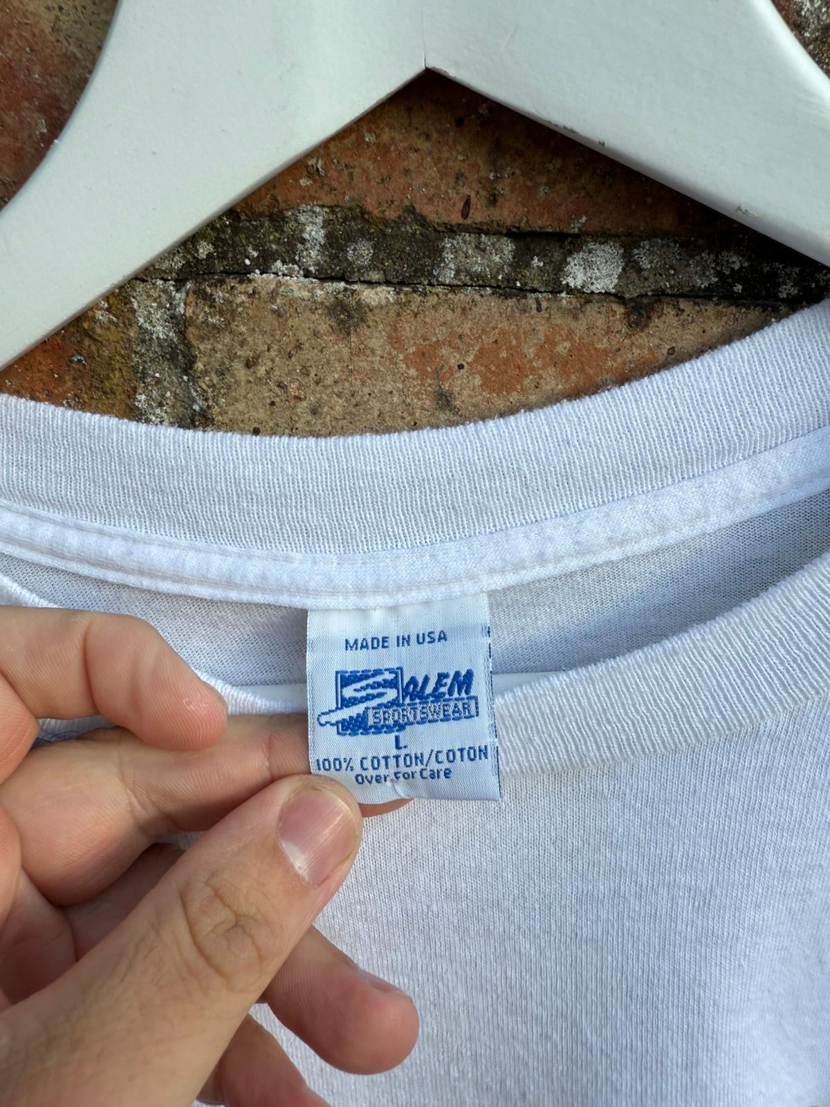 White t-shirt with a label held by a hand, showing 'Made in USA' text and Salem Sportswear