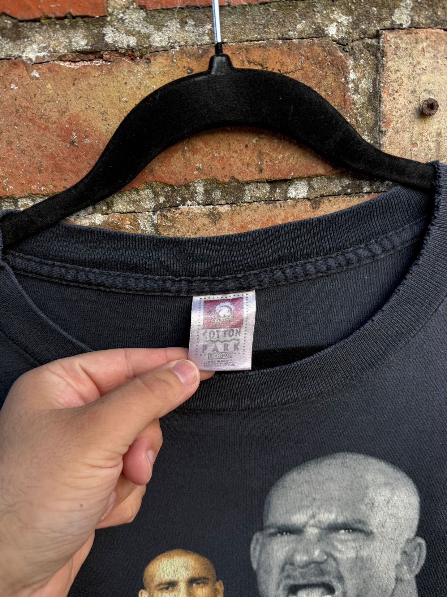 Black t-shirt with a Cotton Park XL tag showing