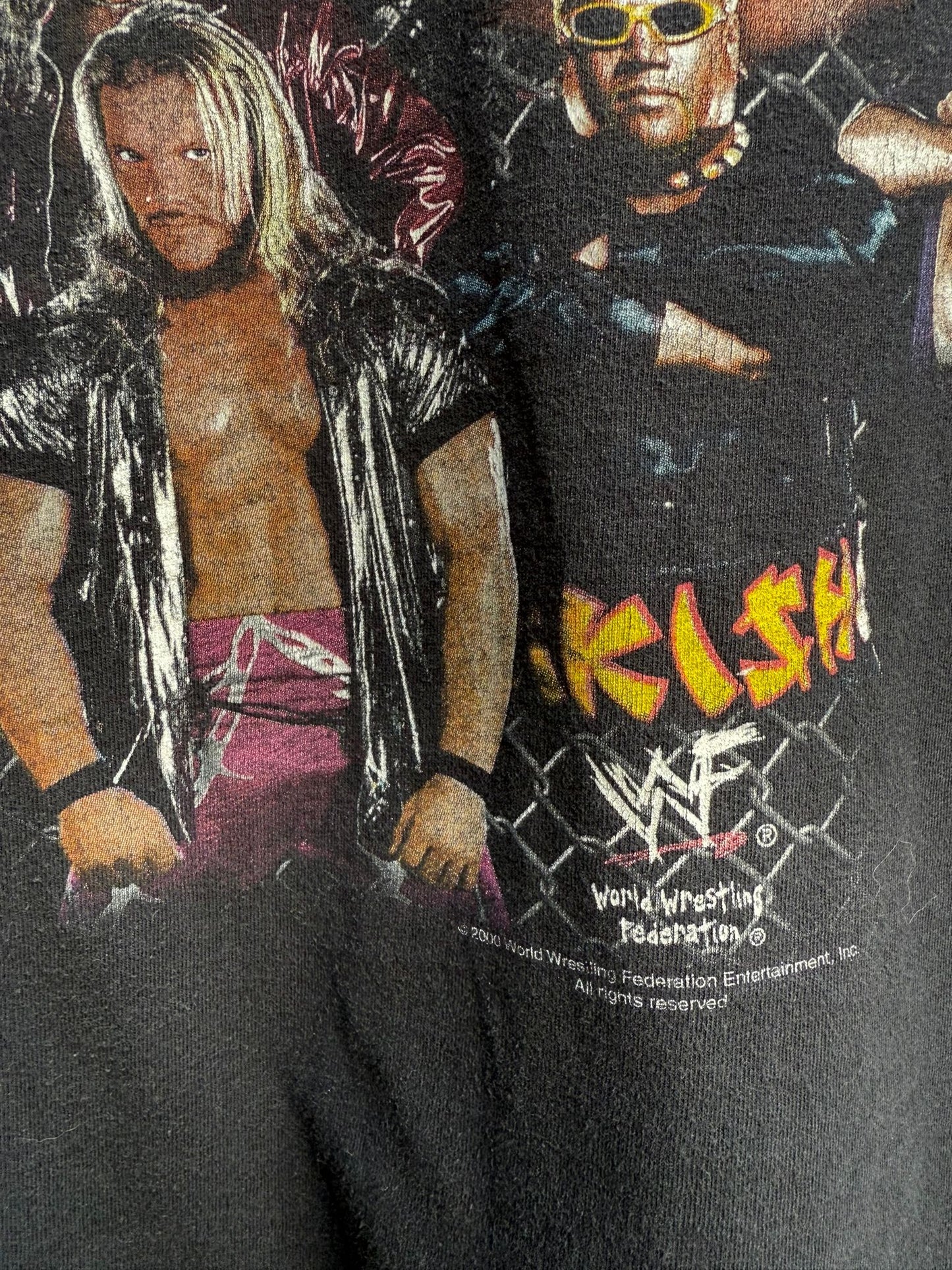 Black t-shirt with WWF graphics and text, featuring two wrestlers in the background.