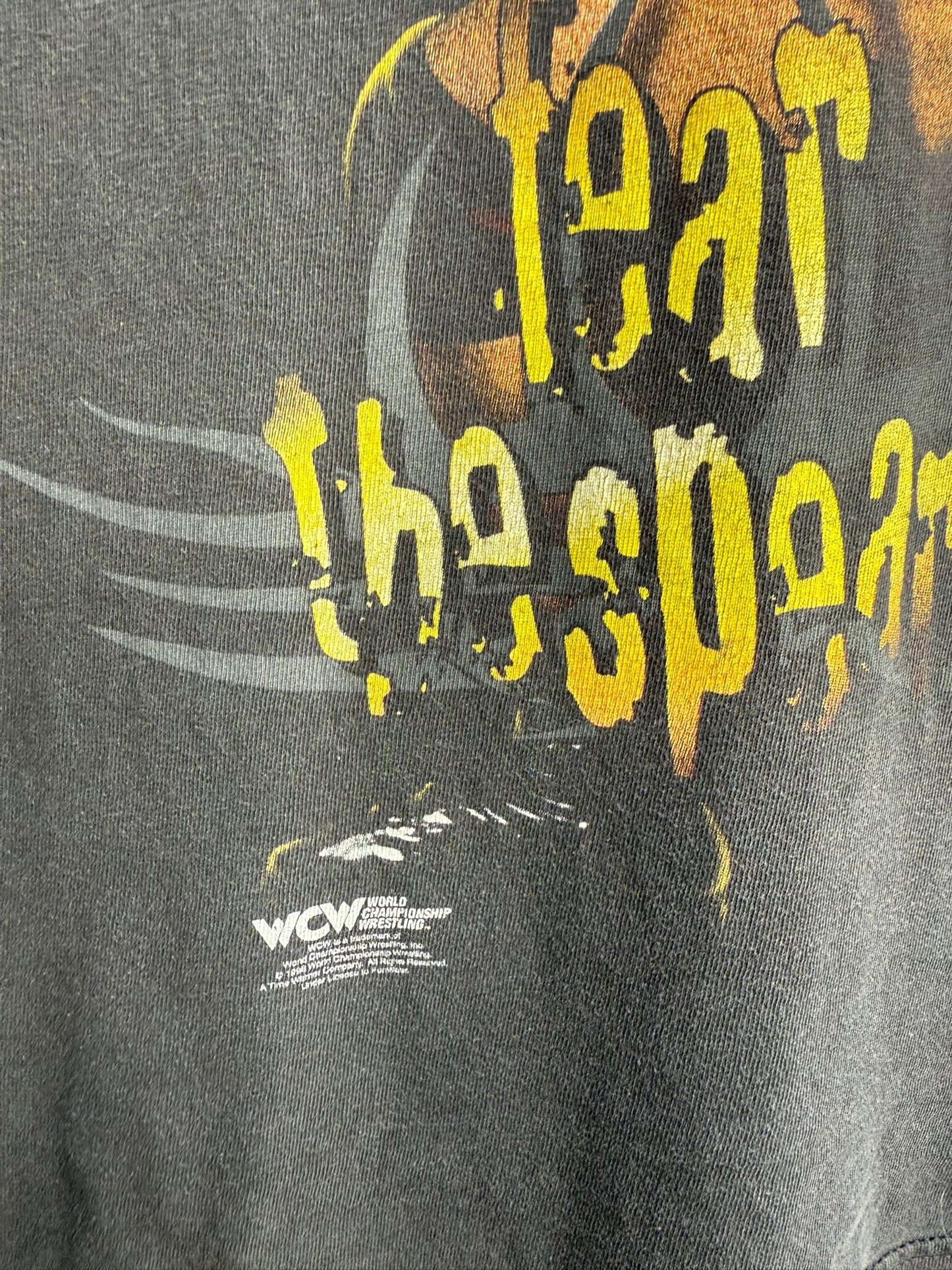 Black t-shirt with yellow text and logo, featuring 'WCW' branding.