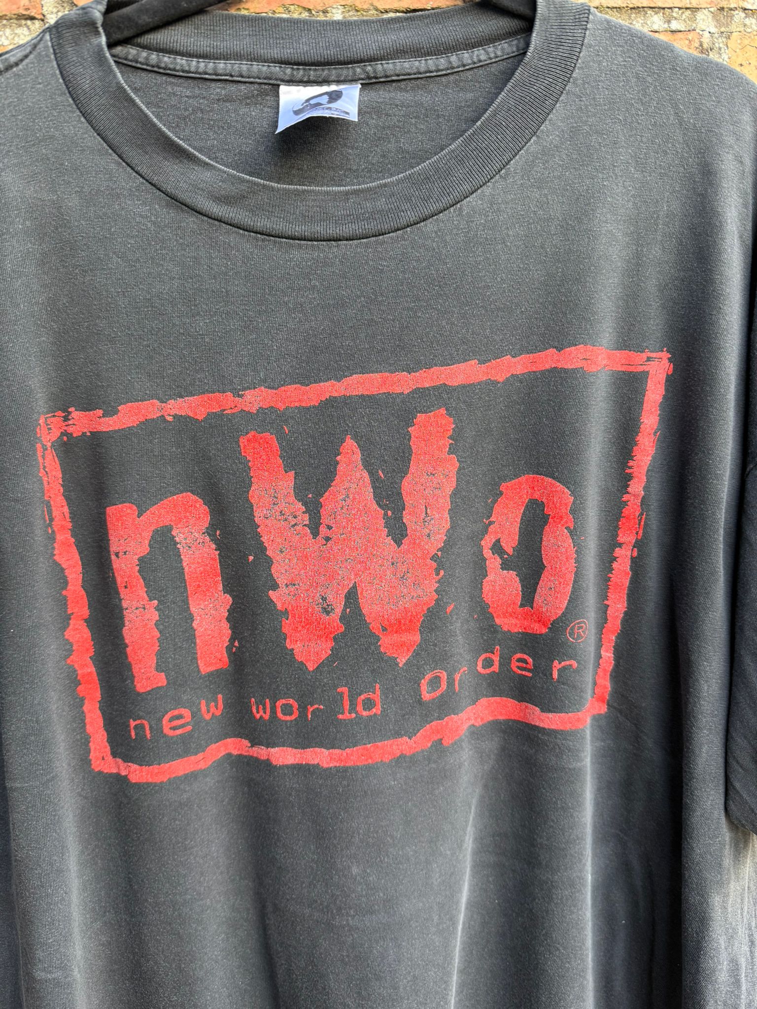Black t-shirt with red 'NWO' logo on the front