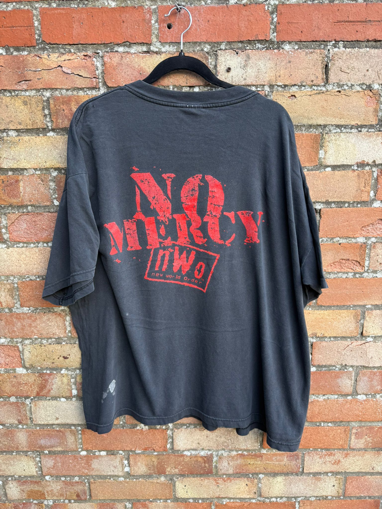 Black t-shirt with red text 'NO MERCY' and nWo logo 