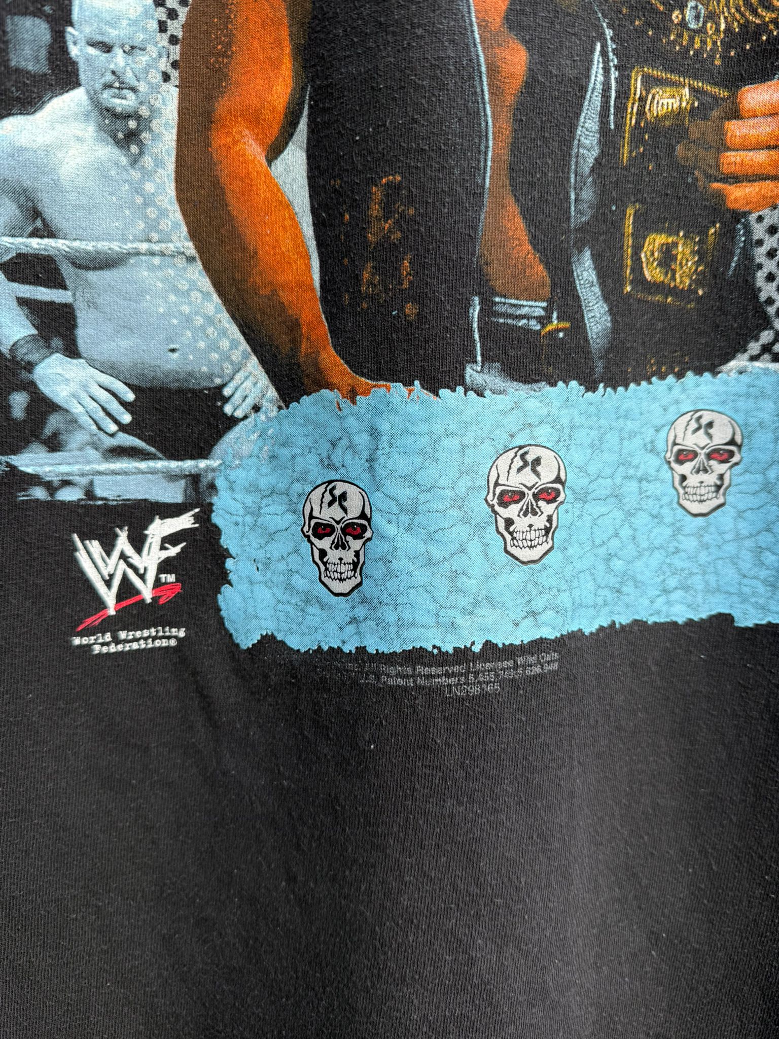Black t-shirt with skull designs and WWF logo