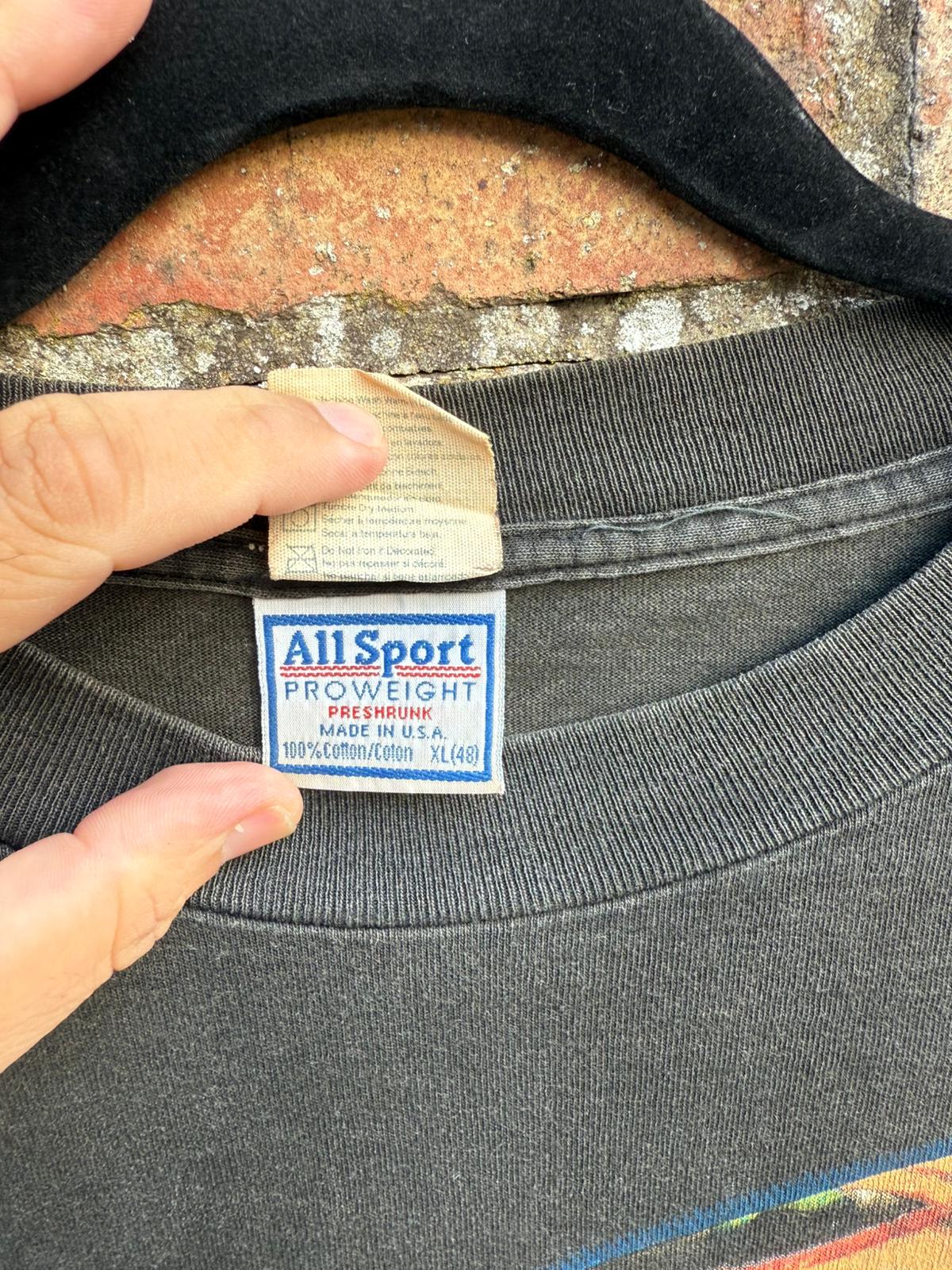 Close-up of an All Sport Proweight label on a black t-shirt