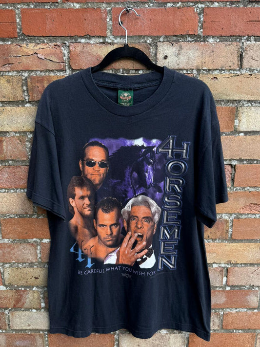 Black t-shirt with graphic design of four men and text '4 Horsemen' on a brick wall background