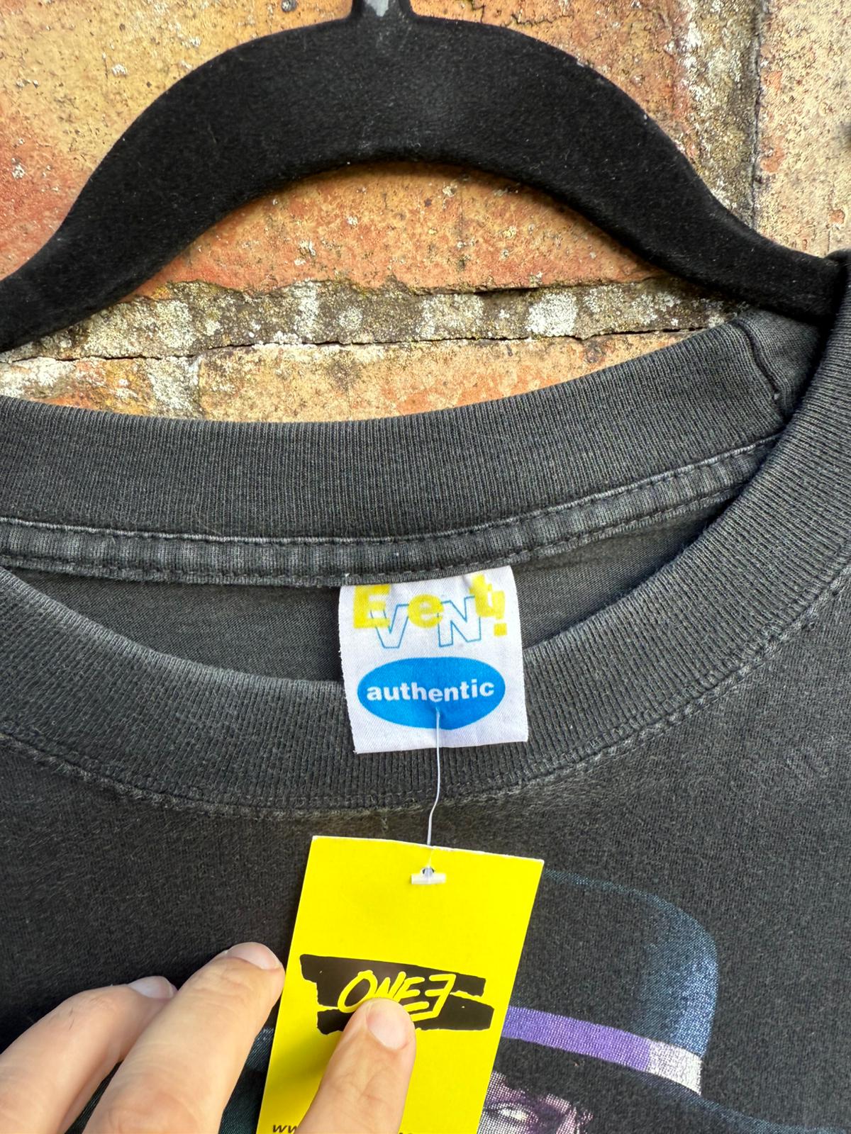 Black t-shirt with an Event Authentic visible tag on a textured surface