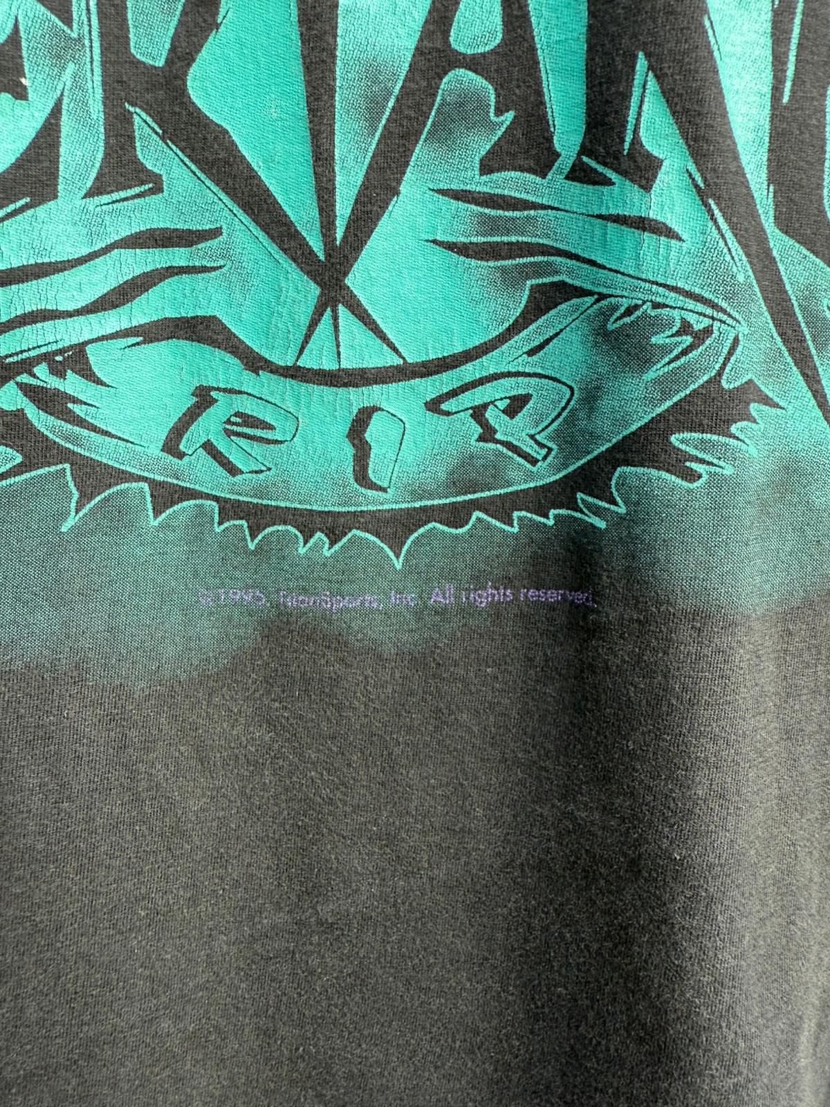 Close-up of Undertaker RIP graphic design on a shirt with Titan Sports Inc Branding