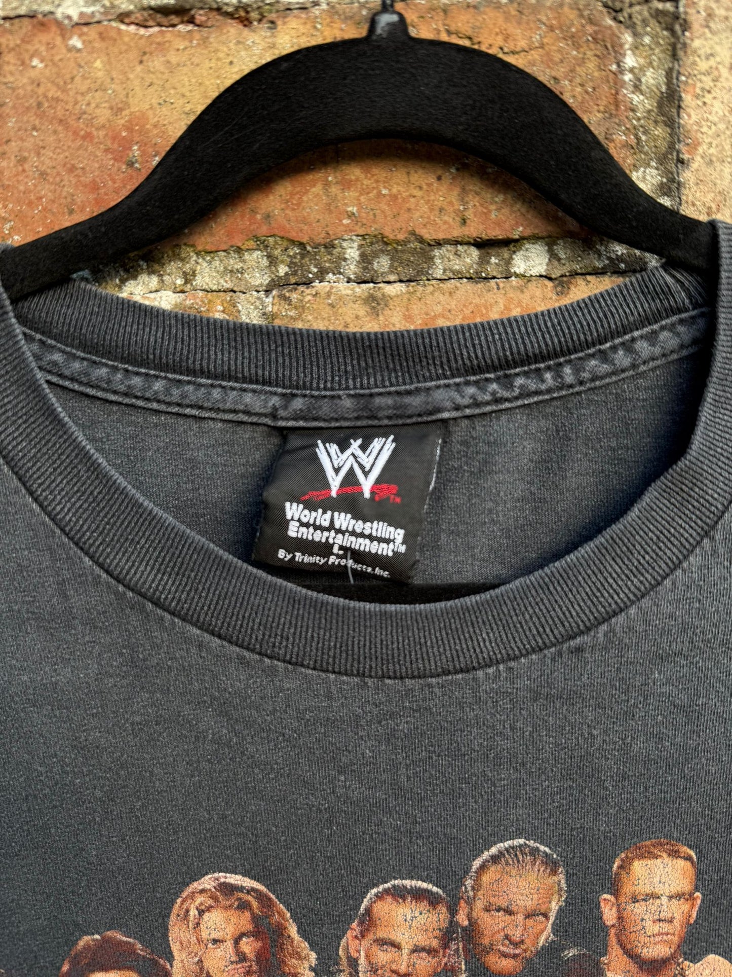 Black t-shirt with printed WWE tag showing