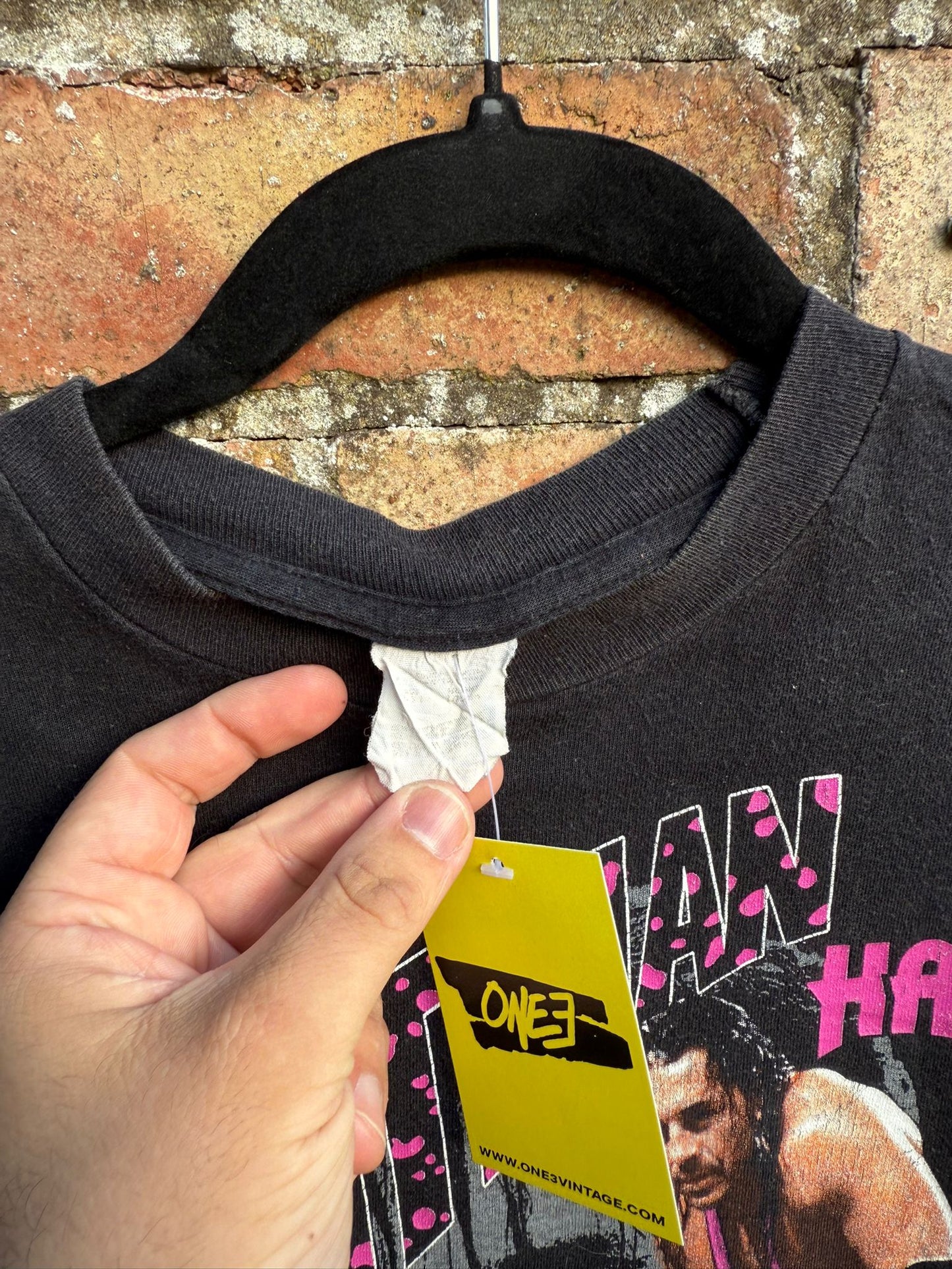 Washed out tag from black wrestling t-shirt produced by Titan Sports