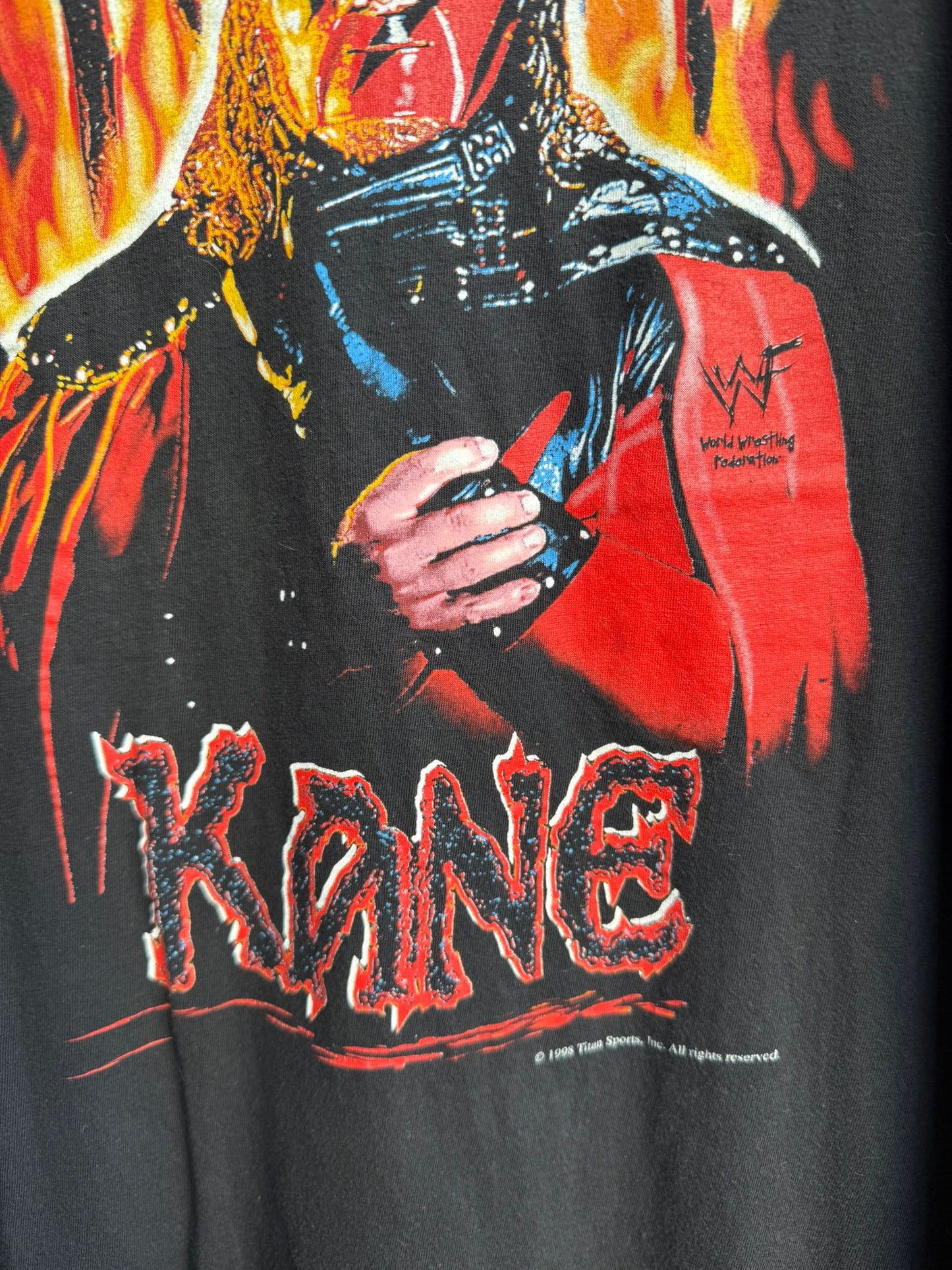 T-shirt with a graphic design of flames and the word 'Kane' on a black background.