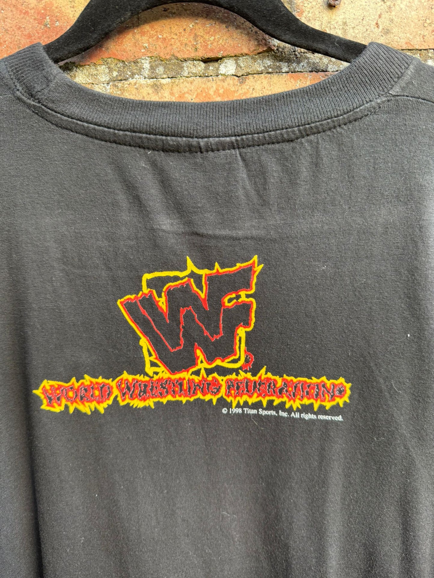 Black T-shirt with 'WWF' logo on a textured surface