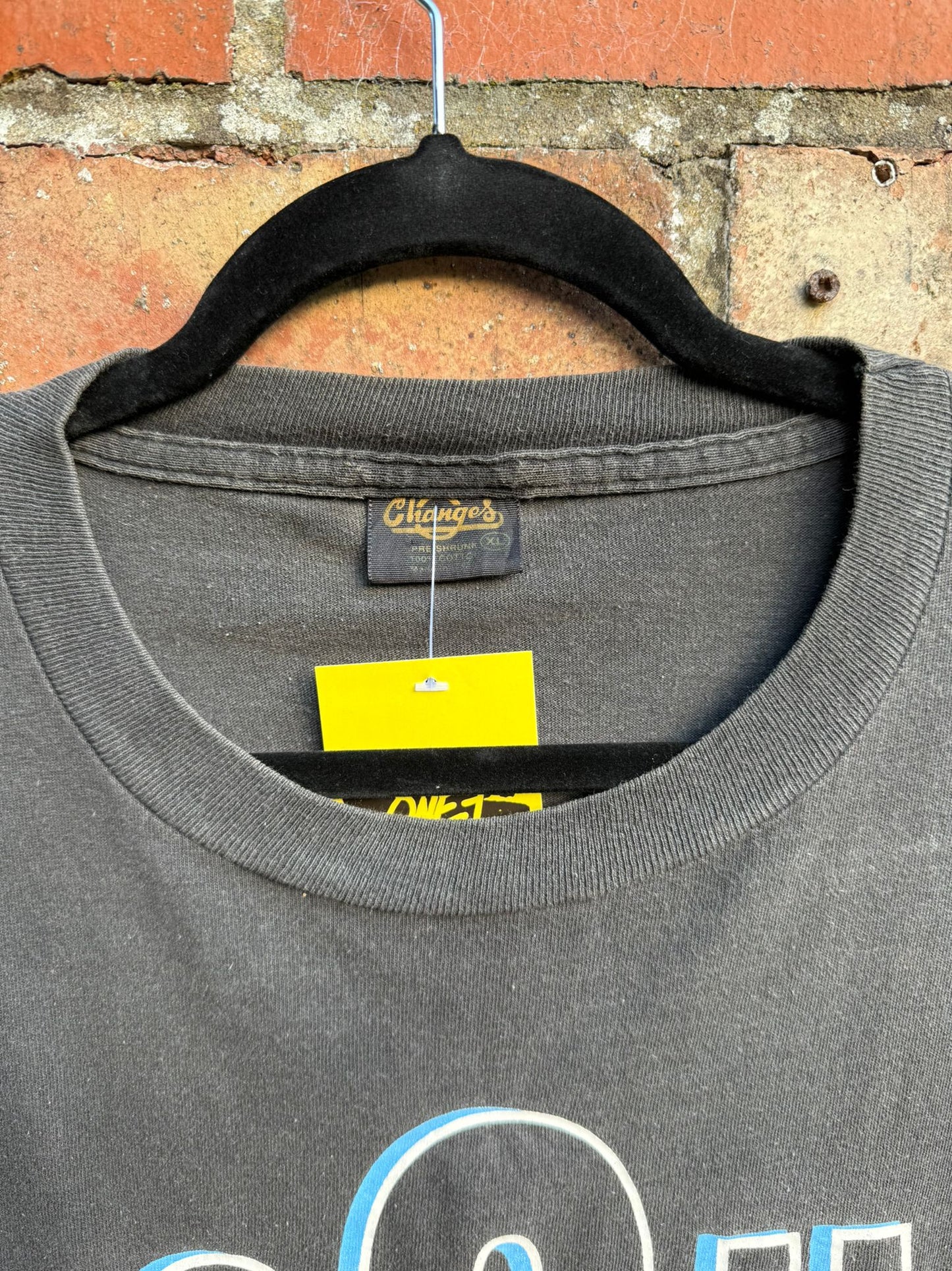 Close up of Changes tag on a black t-shirt