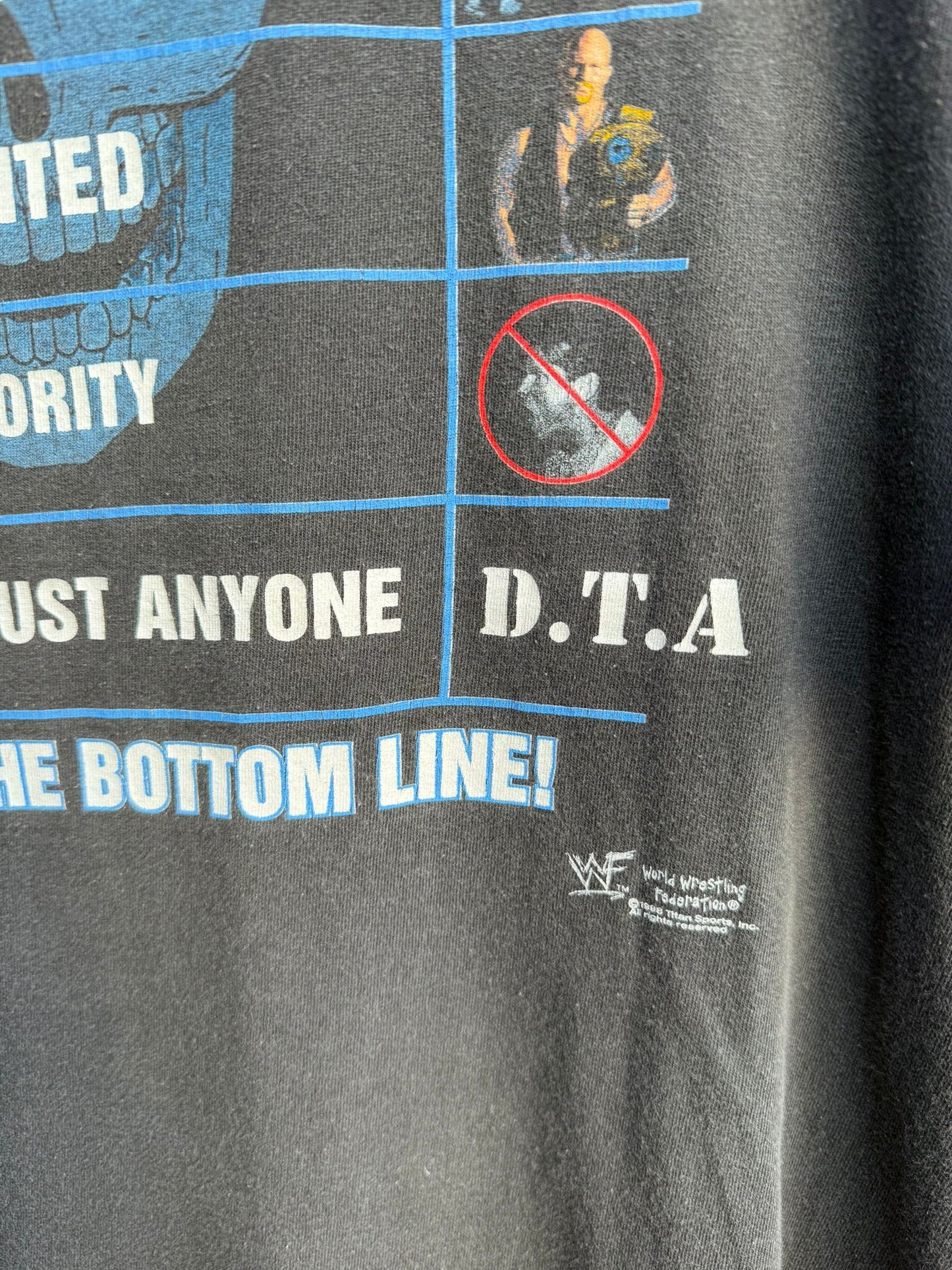 Black t-shirt with WWF logo and branding and some text D.T.A