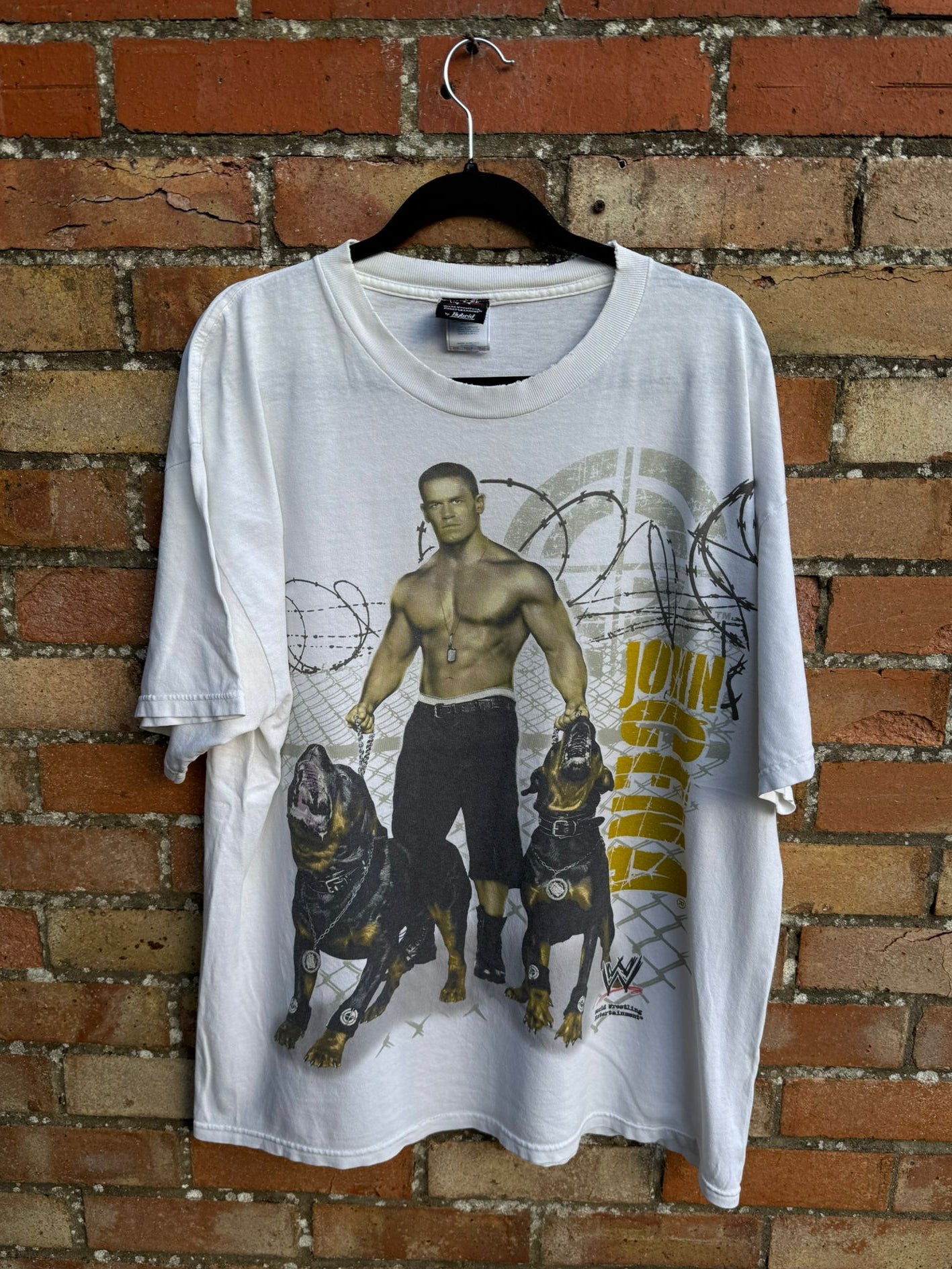 White t-shirt with graphic design of John Cena with two dogs 