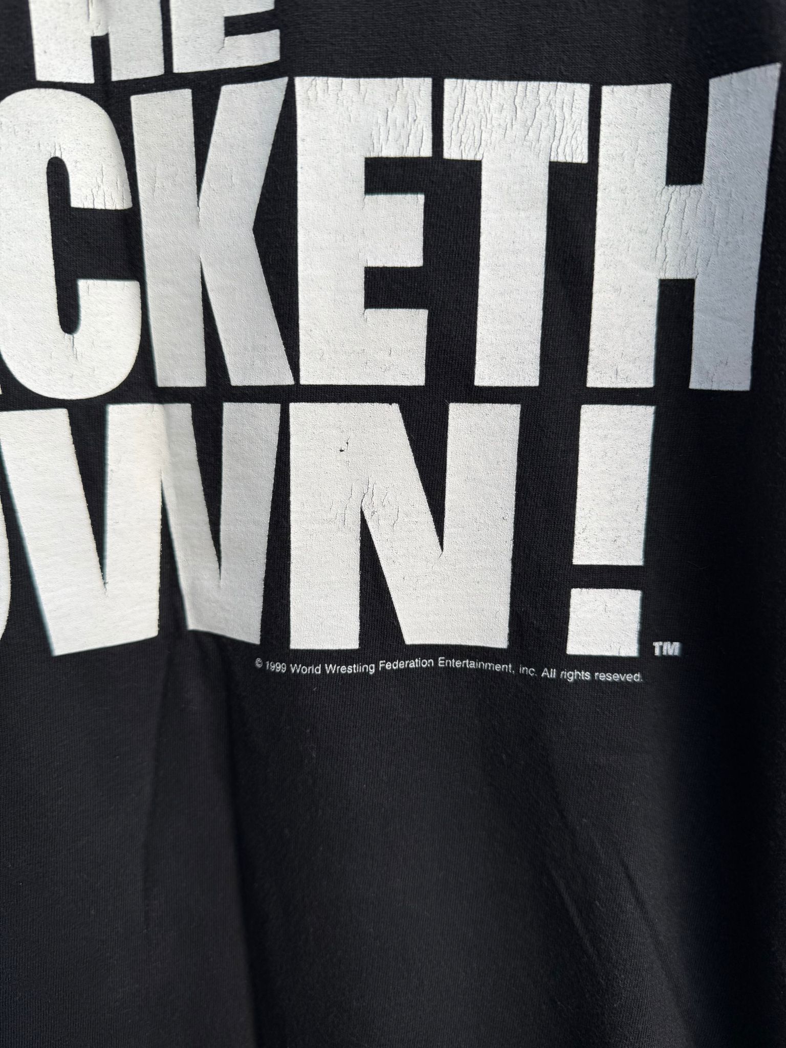 Black t-shirt with white text on a black background with WWF branding