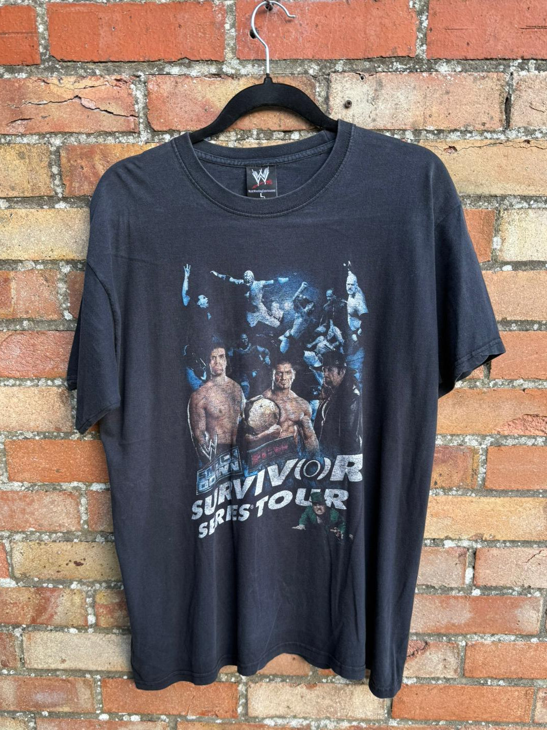 Black t-shirt with wrestling graphic for Survivor Series Tour