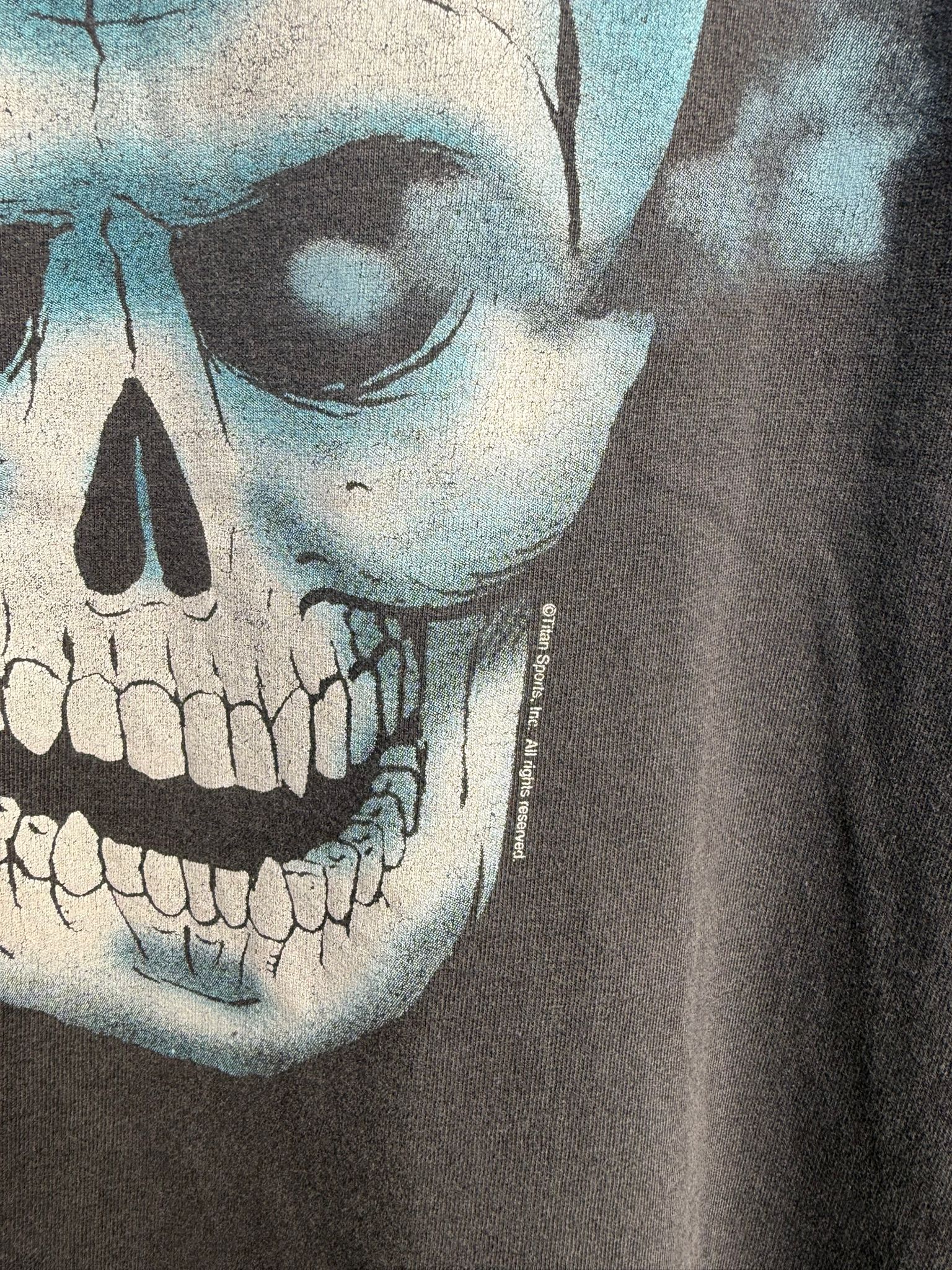 Close-up of a graphic t-shirt with a skull design and a Titan Sports Inc copyright statement