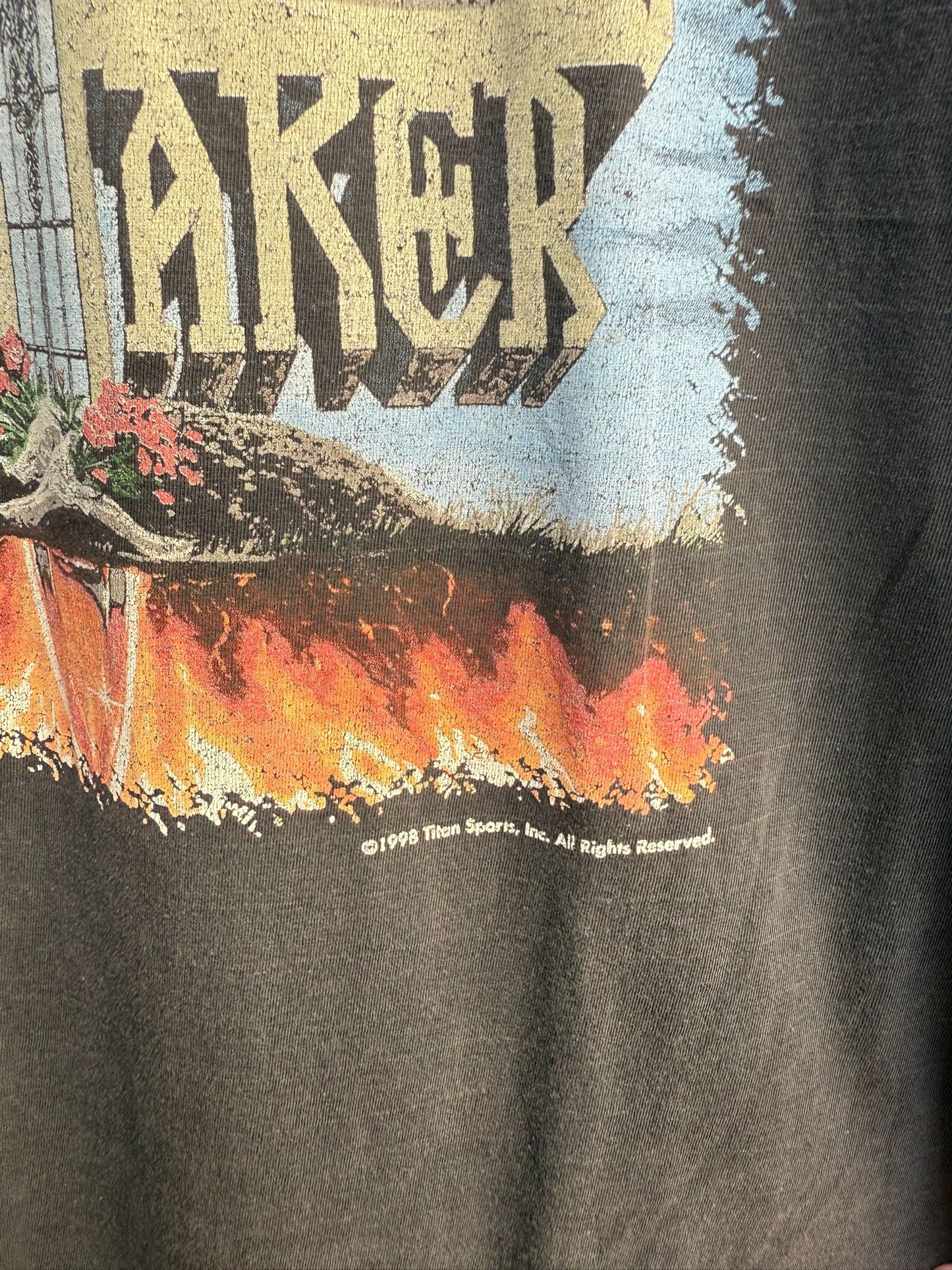 T-shirt with graphic design and Titan Sports 1998 copyright text on a black background