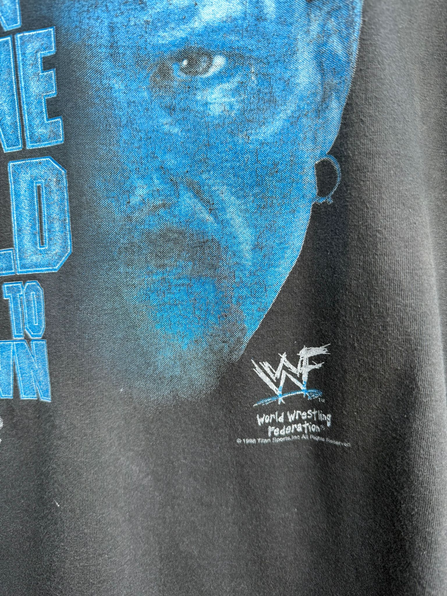 Black t-shirt with blue Steve Austin graphic face and WWF logo