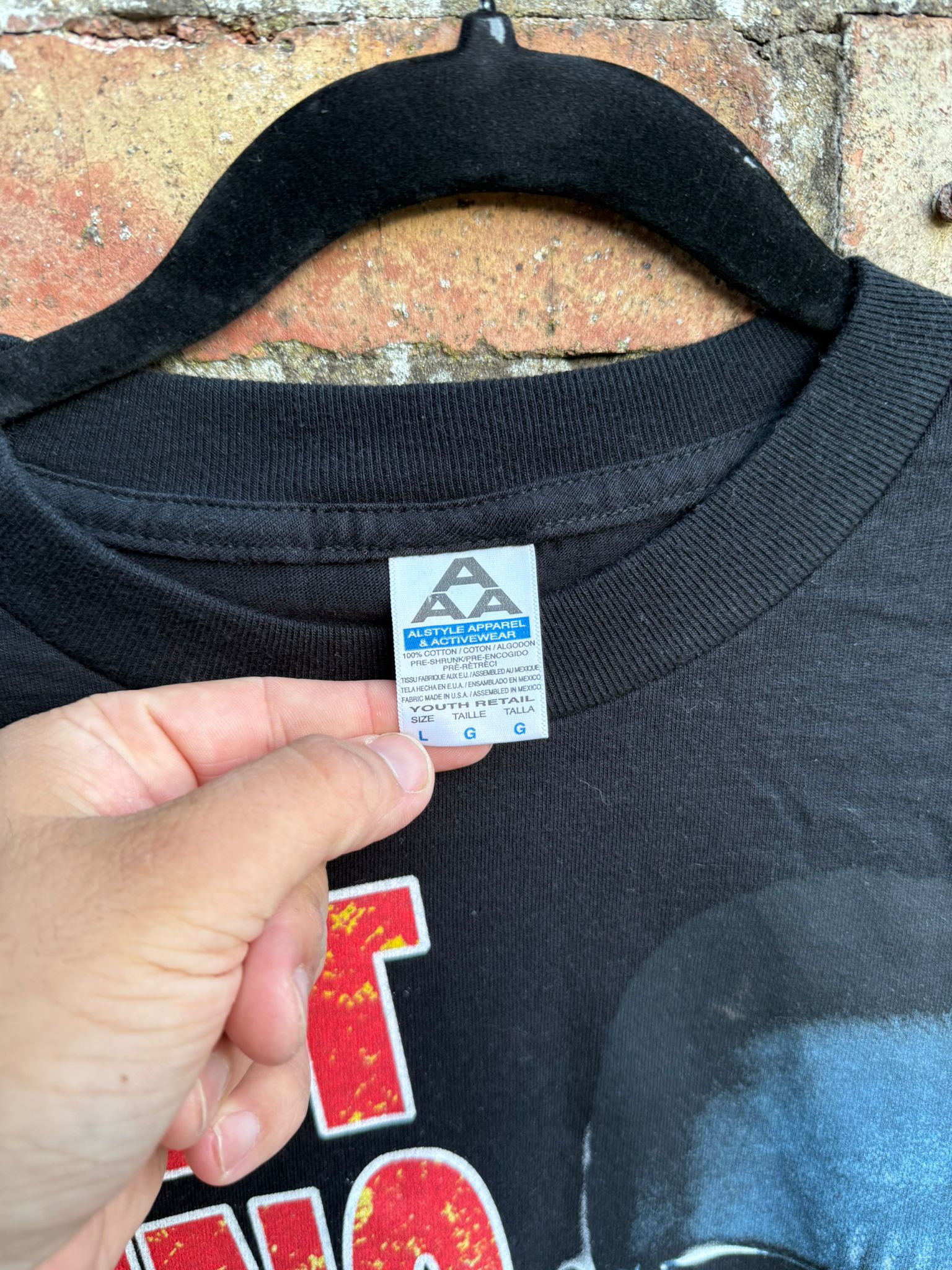 Black t-shirt with close-up of AAA tag size L