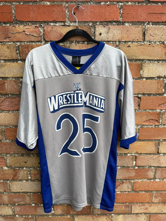 WrestleMania 25 jersey on a hanger against a brick wall