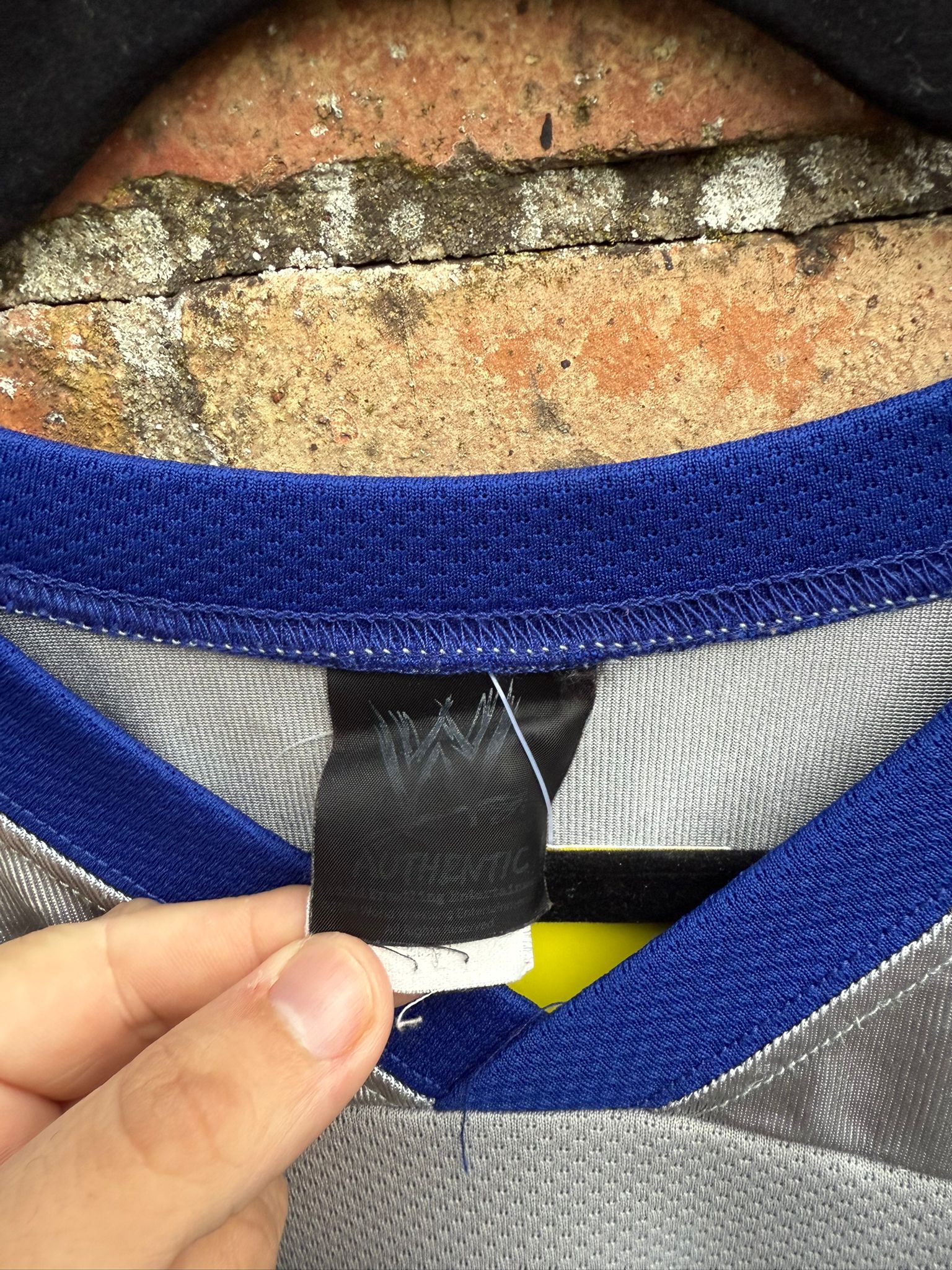 Close-up of a sports jersey with a WWEbrand label on a textured surface