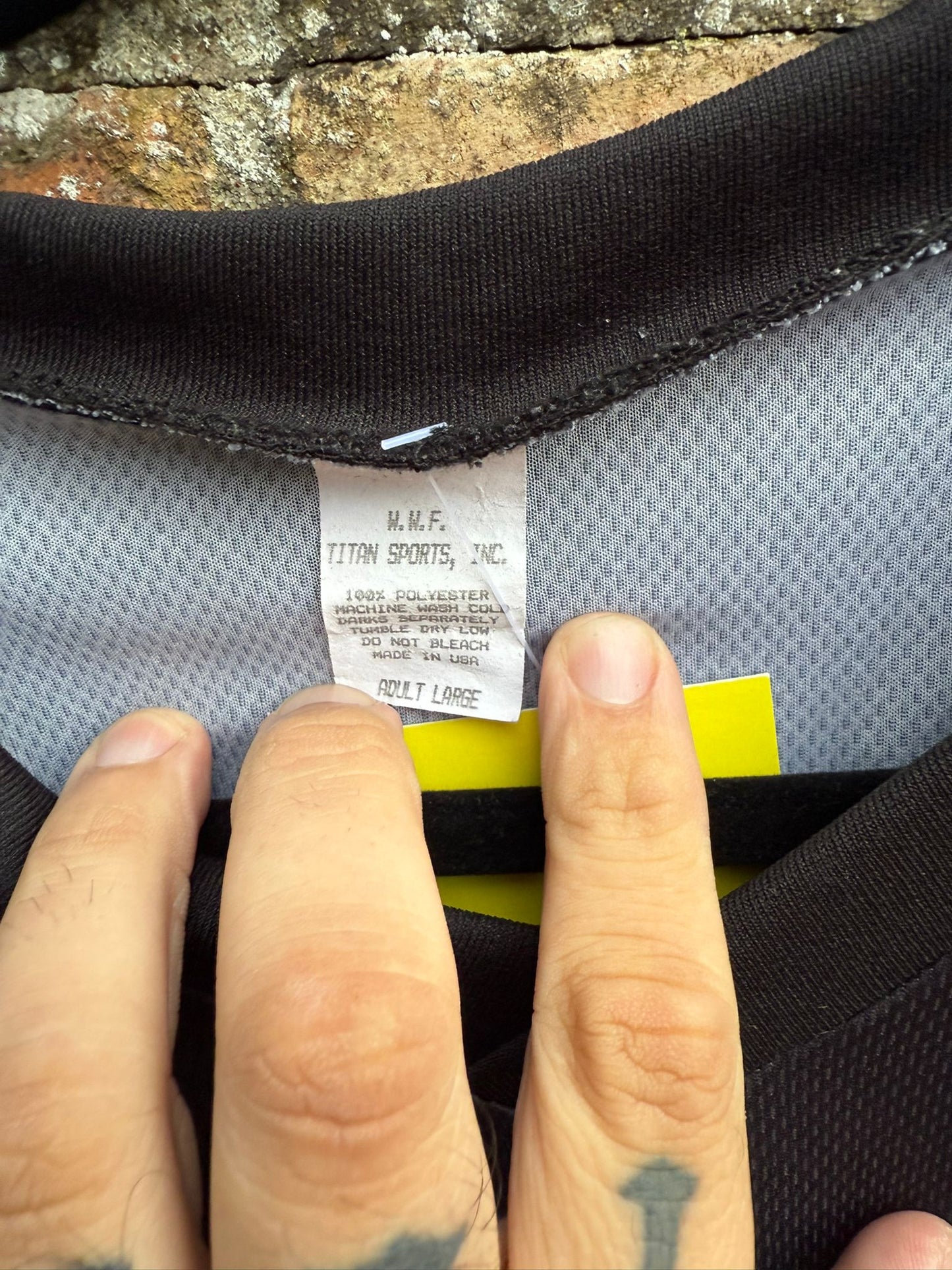 Close-up of a white WWF label Titan Sports Inc on a jersey shirt