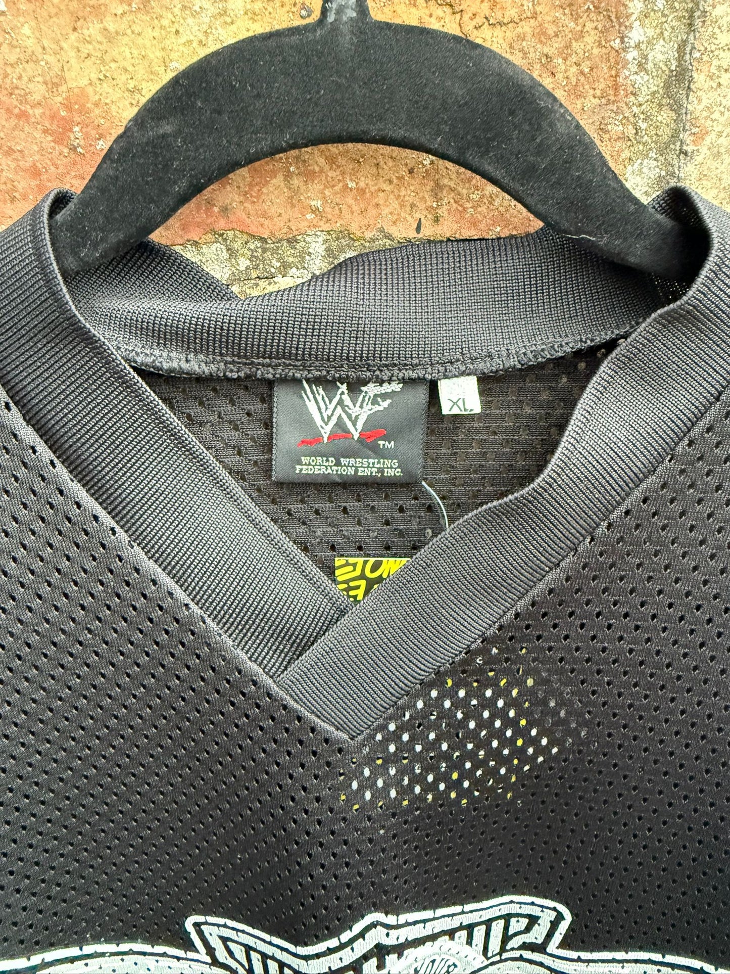 Black sports jersey with WWF logo on a textured background